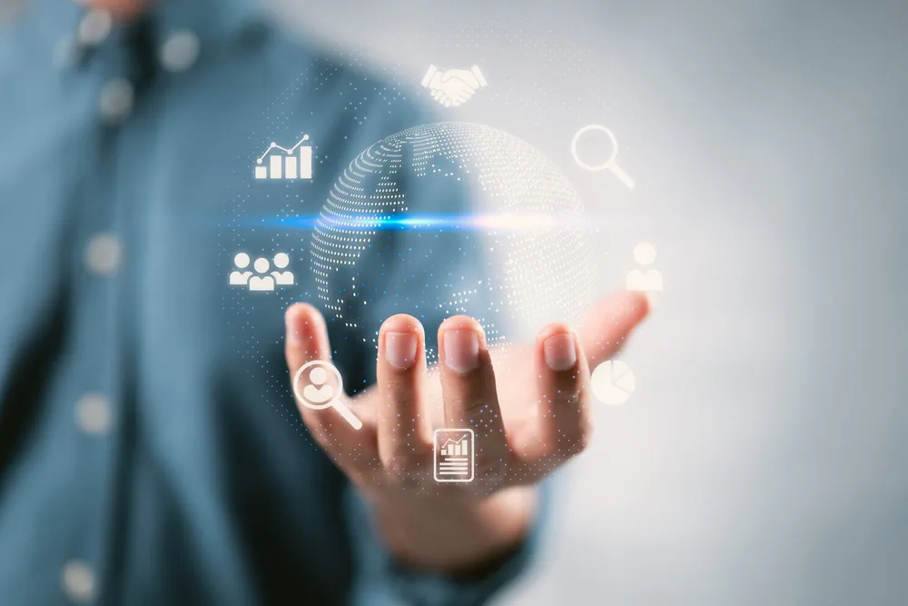 Hand holding a digital network of business icons