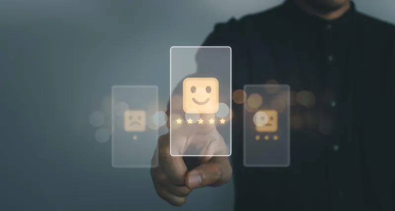 Hand selecting a smiling face on a satisfaction rating