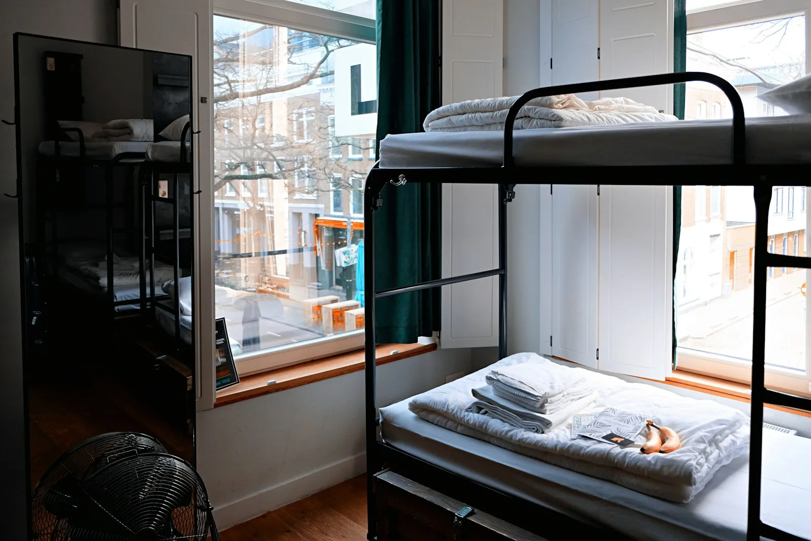 Clean hostel room with made-up beds near UNILAG