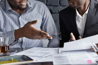 Consultant reviewing documents with a client