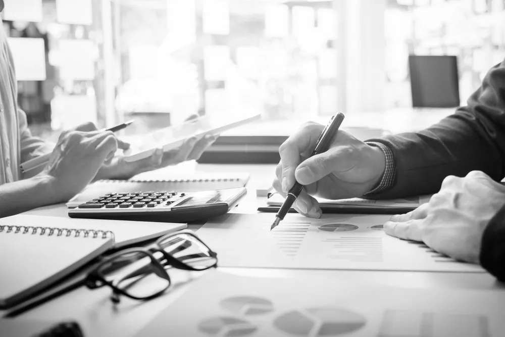Accountant reviewing financial reports with a calculator