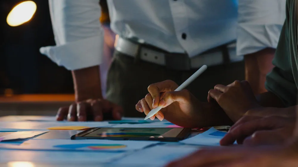 Team mapping out a strategy on a tablet