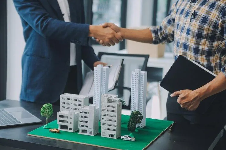 Partners shaking hands over a development model